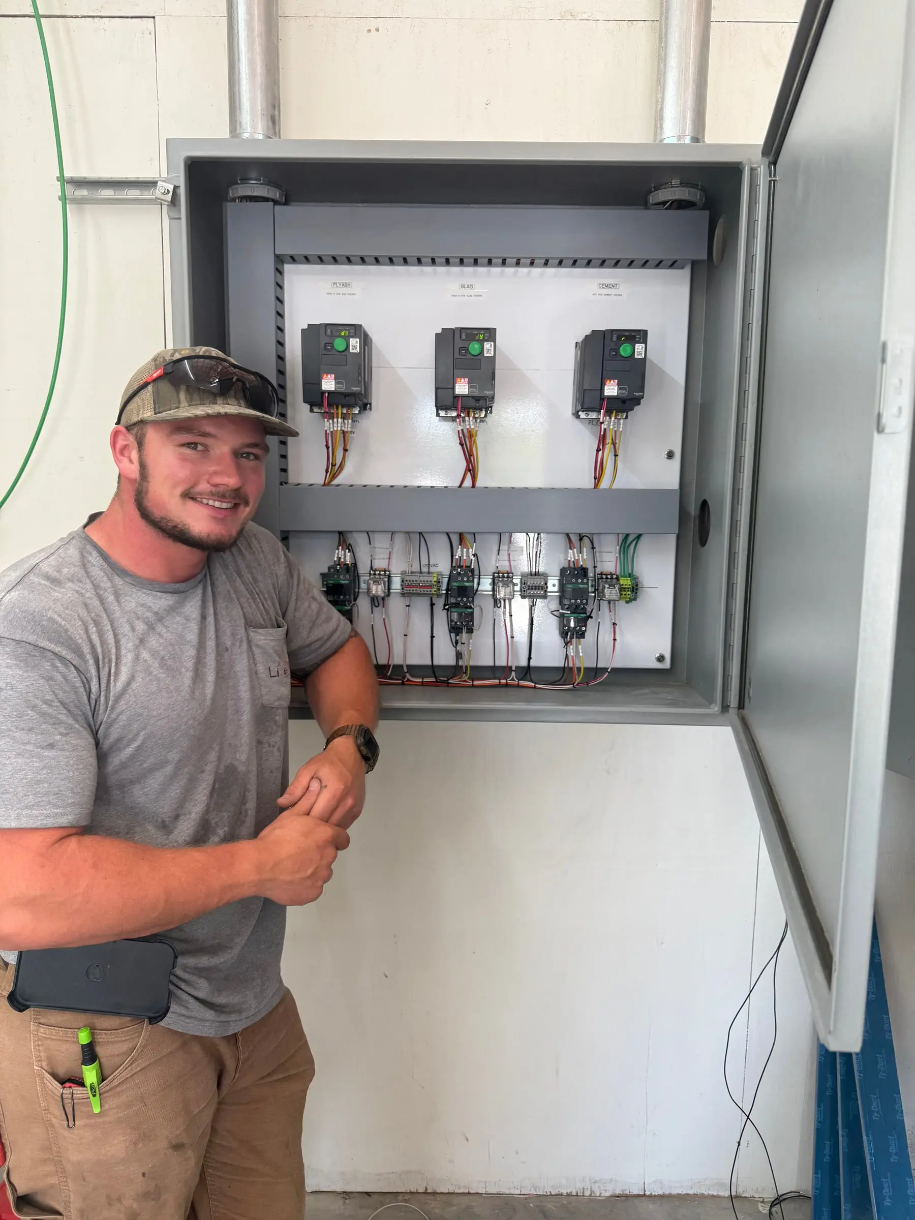 LiveWire Electrical Service electrician with an industrial VFD control panel