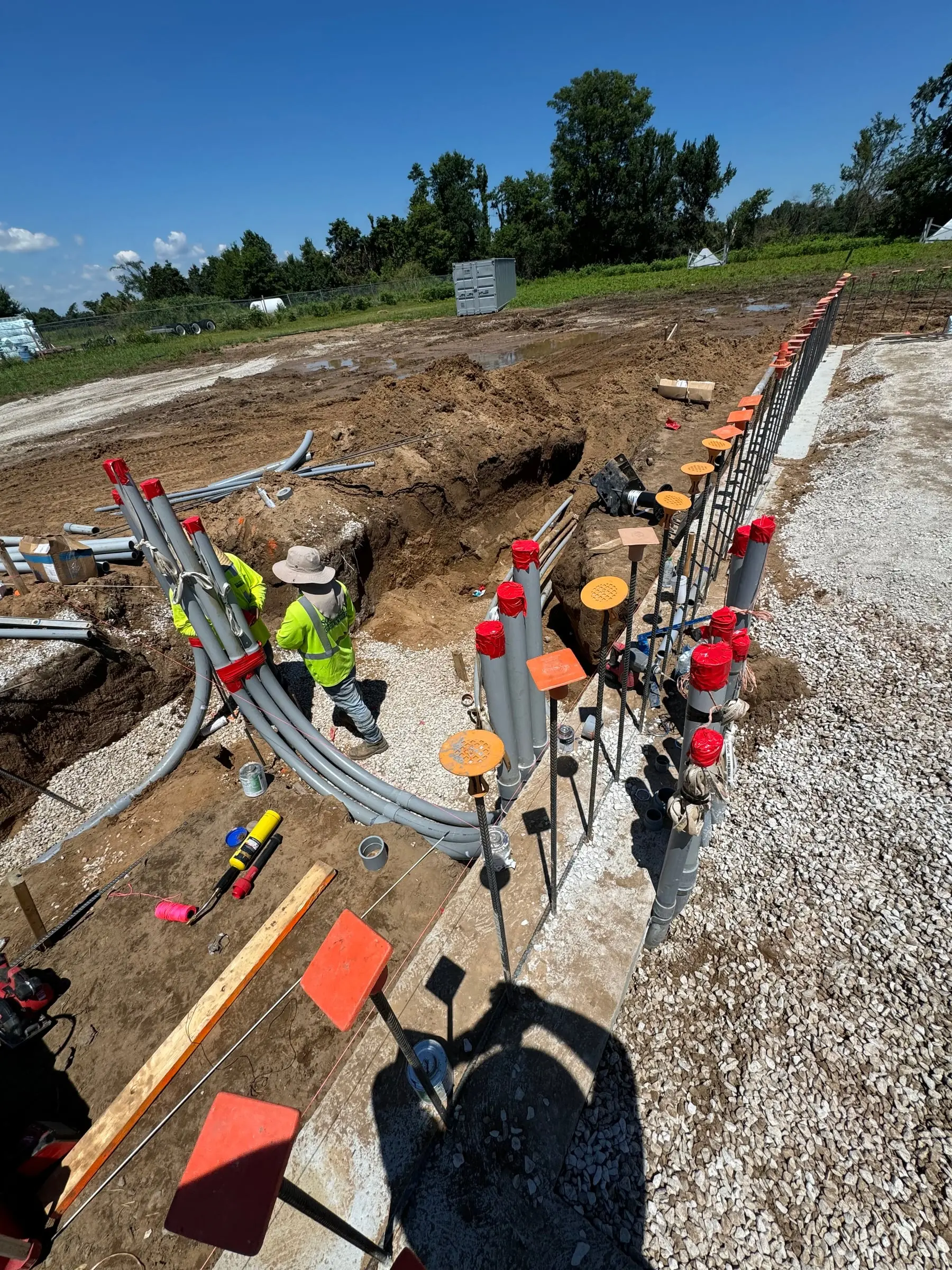 Underground conduit trenching at an industrial electrical site by LiveWire Electrical Service